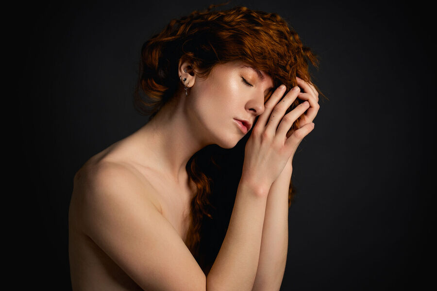 Portrait in a studio against a dark background